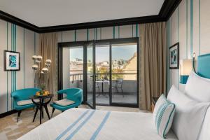 a hotel room with a bed and a balcony at Dinamo Hotel Baku in Baku
