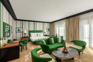 a hotel room with a bed and green furniture at Dinamo Hotel Baku in Baku