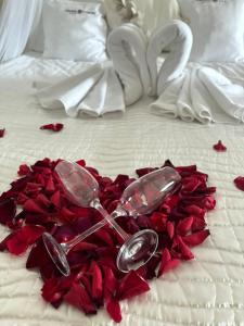 a pile of red rose petals on a bed at Dworek Góralski in Łodygowice