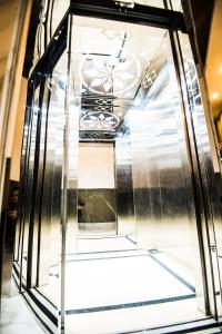 an elevator in a building with a glass case at 1991 Boutique Hotel in Phan Thiet