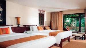 a hotel room with two beds and a window at Paradox Resort Phuket in Karon Beach +122 photos