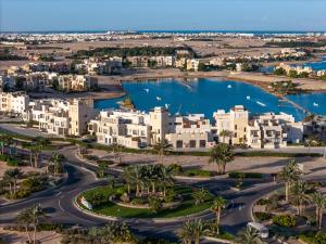 Creek Hotel and Residences El Gouna في الغردقة: اطلالة جوية على مدينة فيها بيوت وبحيرة