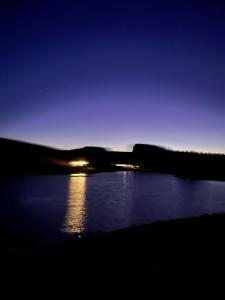 a view of a body of water at night at East Learmouth Lakeside Lodges in Cornhill-on-tweed