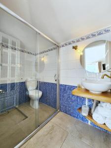 a bathroom with a shower and a sink and a toilet at Aya Butik Otel in Istanbul