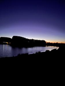 a view of a lake at night at East Learmouth Lakeside Lodges in Cornhill-on-tweed