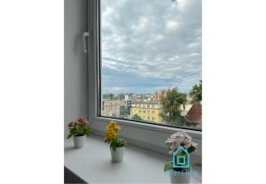 a window with a view of a city at Droid Room in Gdynia