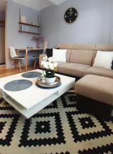 a living room with a couch and a coffee table at Apartamenty NOVA na Krakowskiej No 2 in Bielsko-Biala