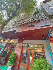 a building with glass doors in front of it at Hostel by Monsoon Riverside in Phnom Penh