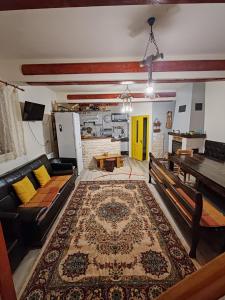 a living room with a couch and a table at CEZARA Ski Lake View in Beliş
