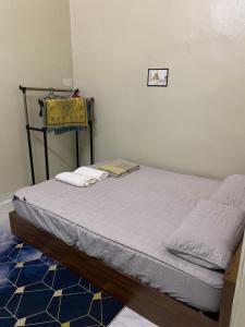 a bedroom with a bed with a yellow purse on it at Homestay Sejati in Kuala Berang