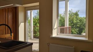 a kitchen with a window with a view of a deck at Guest House Kamara in Panevėžys