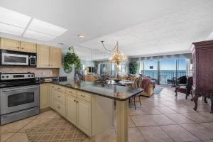 a kitchen and living room with a view of the ocean at Arcadian Getaway - Oceanfront Condo, With Pool and Wifi, Monthly Winter Rental in Myrtle Beach