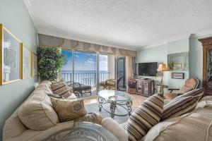 a living room with a couch and a table at Arcadian Getaway - Oceanfront Condo, With Pool and Wifi, Monthly Winter Rental in Myrtle Beach