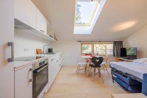 a kitchen and dining room with a bed and a table at Apartmenthaus A24 in Schruns