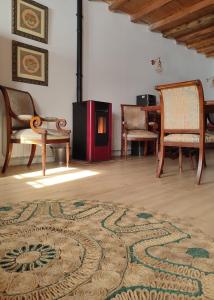 a living room with two chairs and a fireplace at Casa Rural Casona Camino Pedraza - 4 Estrellas in Arcones