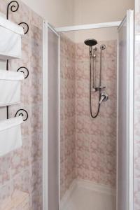 a shower with a glass door in a bathroom at M355 - Marcelli, bilocale con giardino e parcheggio in Marcelli +14 photos