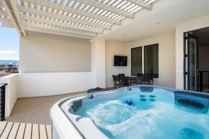 a jacuzzi tub in a room with a patio at Paddle and Play townhouse in St. George