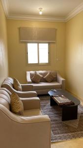 a living room with two couches and a table at شقق العاصفه4 in Khamis Mushayt