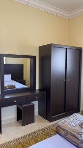 a bedroom with a large mirror and a bed at شقق العاصفه4 in Khamis Mushayt