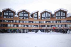 a large building with snow on top of it at New Gudauri, Building: Block 4, Near Gondola ski elevator in Gudauri