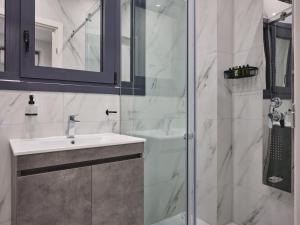 a bathroom with a sink and a shower at Athens Project Luxury Apartments in Athens