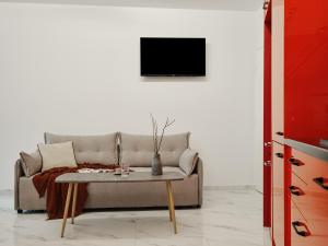 a living room with a couch and a table at Athens Project Luxury Apartments in Athens
