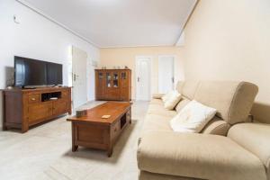 a living room with a couch and a tv at Charming Villa in Lliria w/ Private Pool & Garden in Lliria