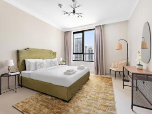 a bedroom with a large bed and a large window at Brand New Spacious 2BDR Dubai Creek Residences - South in Dubai