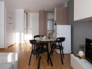 a kitchen and dining room with a table and chairs at Studio na Ochocie lotnisko FV in Warsaw