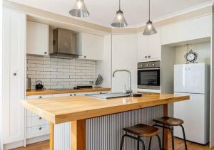 a kitchen with a wooden counter top and a refrigerator at Antique Retreat in Bathurst