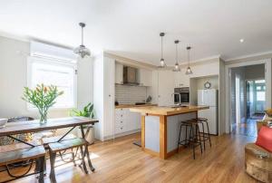 a kitchen and living room with a table and chairs at Antique Retreat in Bathurst
