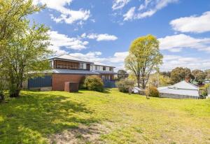 a house with a lawn in front of it at Antique Retreat in Bathurst