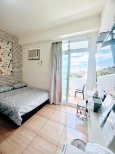 a bedroom with a bed and a large window at Zheng Yi Homestay in Taitung City