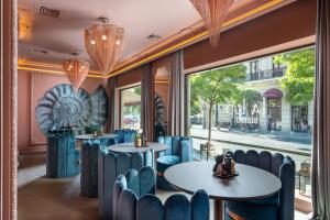 a restaurant with blue chairs and tables and a window at VISIONAPARTMENTS Bucharest Calea Victoriei in Bucharest