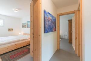 a bedroom with a bed and a door to a bathroom at Chesa Lagrev 1 in Sils Maria
