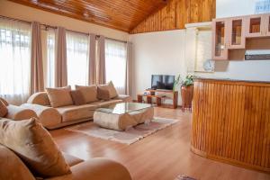 a living room with a couch and a coffee table at United nations Bluezone stunning spacious cottage in Nairobi