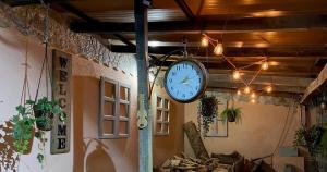 a clock hanging from a wall in a room at Casa rural O CARBALLO DA PEDRA in La Cañiza
