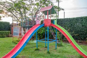 a colorful playground slide in a yard at Unique 2BR United Nation bluezone perimeter in Nairobi