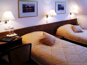 Posteľ alebo postele v izbe v ubytovaní Hotel Restaurant Modrá Hvězda