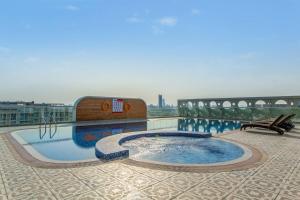 a swimming pool on the roof of a building at Nasma Luxury Stays - Sleek City Haven 1BR in Dubai's Glitz Residence 3 in Dubai