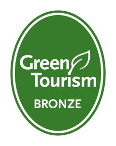 a green tourism promise sign in a green circle at Millennium & Copthorne Hotels at Chelsea Football Club in London