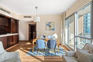 a dining room with a table and chairs at Fountainview Luxe 1BR, sleeps 4 in Dubai