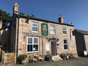 an old stone building with tables and chairs in front of it at Star Cottage - Harbottle - Nr Rothbury - Northumberland in Morpeth +12 photos