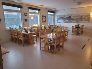 a dining room with wooden tables and chairs at STF Kvikkjokk Fjällstation in Kvikkjokks Kapell