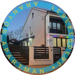a round mirror with a picture of a building at Aranyos Apartman in Hajdúszoboszló