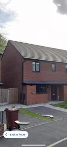 a brick building with a skateboard in a parking lot at Private Modern Ensuite Room near Etihad Stadium in Manchester