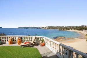 a balcony with chairs and a view of a beach at Balmoral Beach Beauty in Sydney