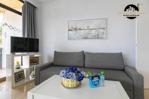 a living room with a couch and a table at Apartamento Castillo Santa Clara 1º Linea El Trasval in Torremolinos