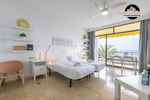 a bedroom with a bed and a table and chairs at Apartamento Castillo Santa Clara 1º Linea El Trasval in Torremolinos