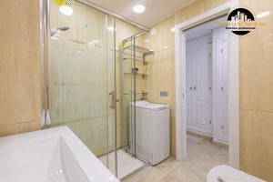 a bathroom with a shower and a sink and a toilet at Apartamento Castillo Santa Clara 1º Linea El Trasval in Torremolinos +29 photos